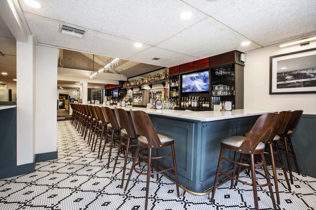 Bar at Tucci’s with multiple high-top seats at counter.