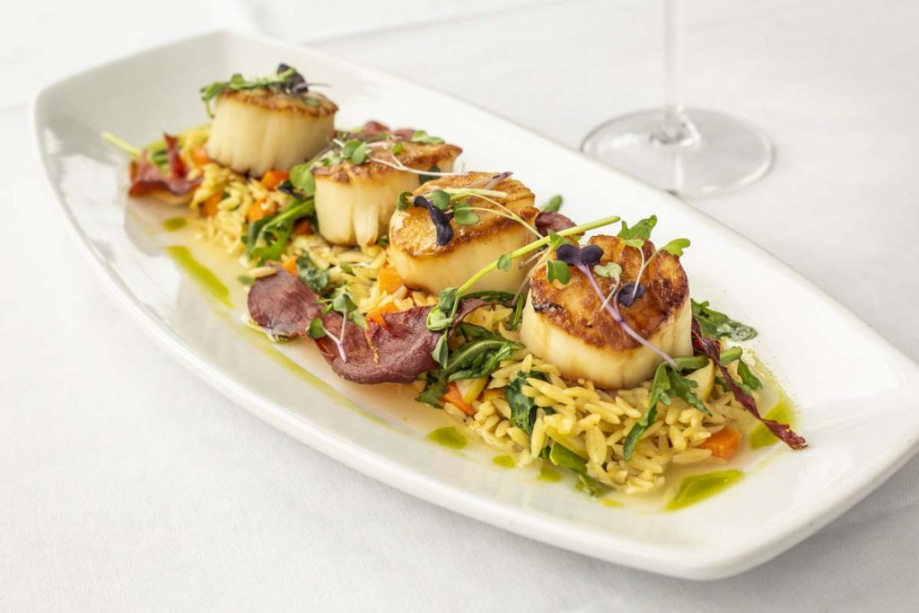 Tucci’s jumbo pan-seared scallops on bed of orzo pasta