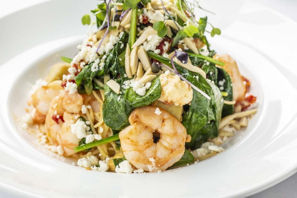 Tucci’s Shrimp with orzo pasta topped with salad greens